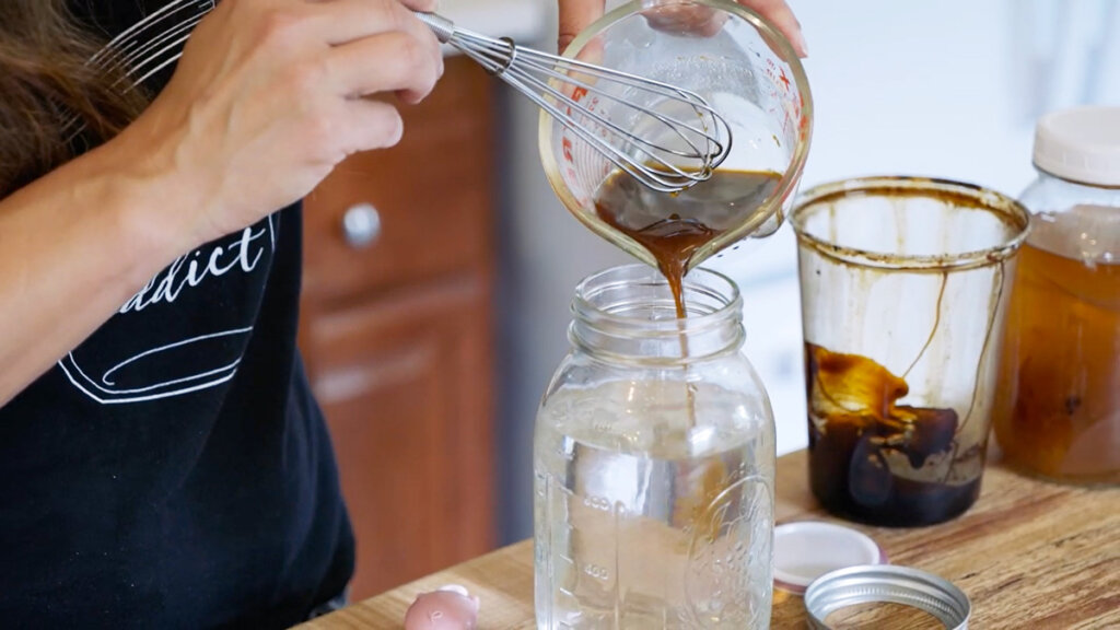 Ginger water mixture being added to a quart of cold water.