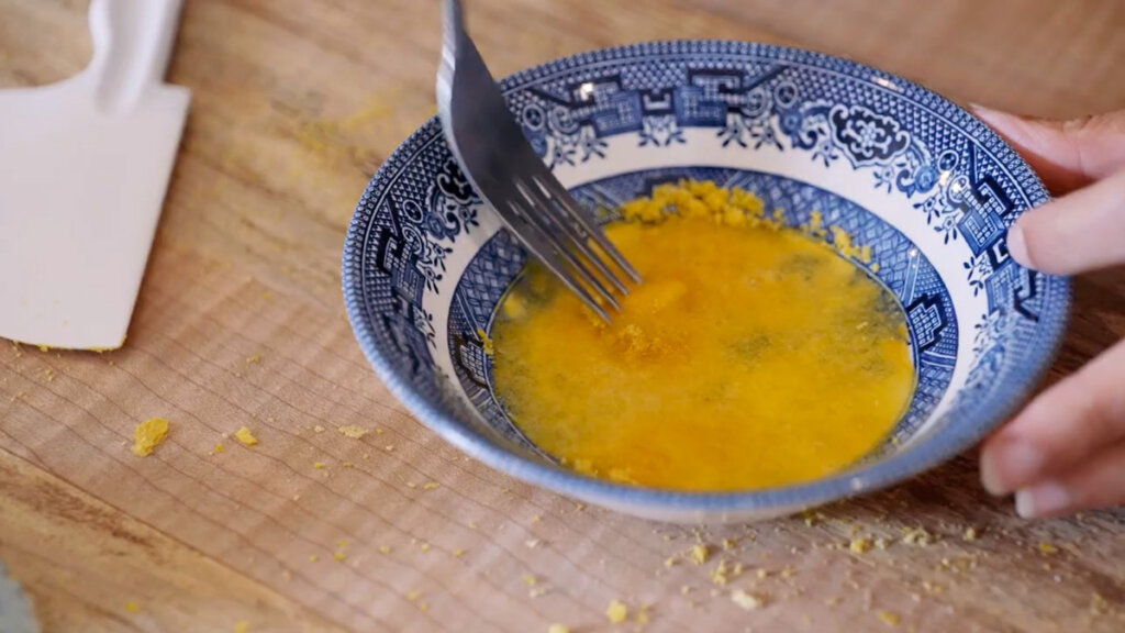 Freeze dried eggs getting reconstituted with water in a bowl.