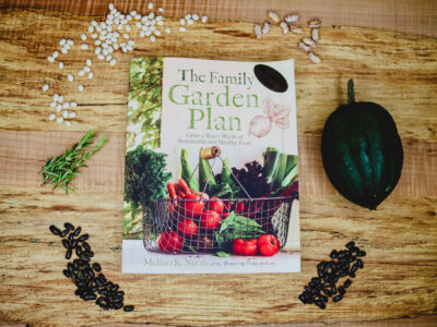 The book, The Family Garden Plan on a wooden table.