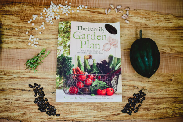 The book, The Family Garden Plan on a wooden table.