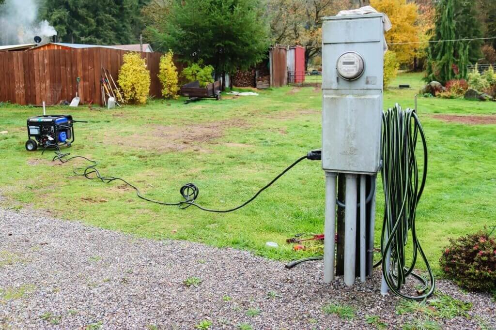 Photo of a generator plugged in to an electrical box.