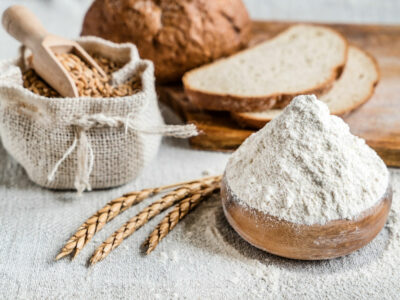 Flour, grains and bread on a counter.