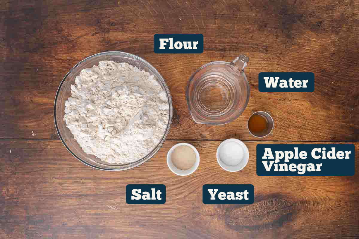 No knead artisan bread recipe ingredients: flour, water, salt, ACV, and yeast.
