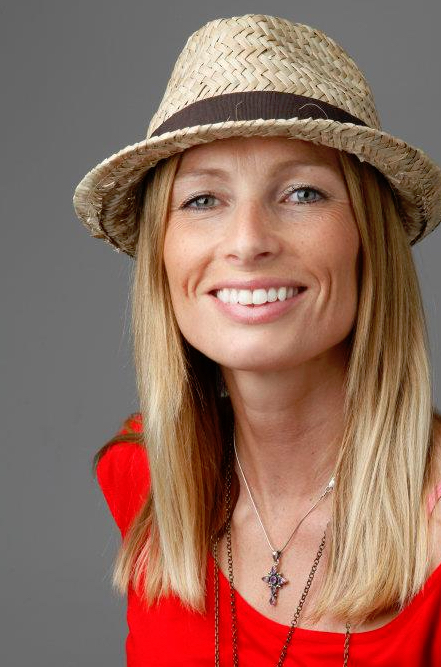 Image of a smiling woman with a hat and red shirt.