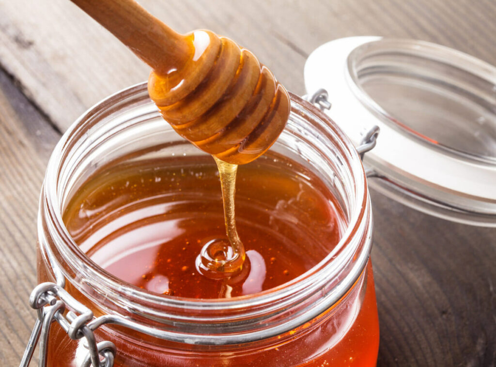 Honey dripping from a honey stick.