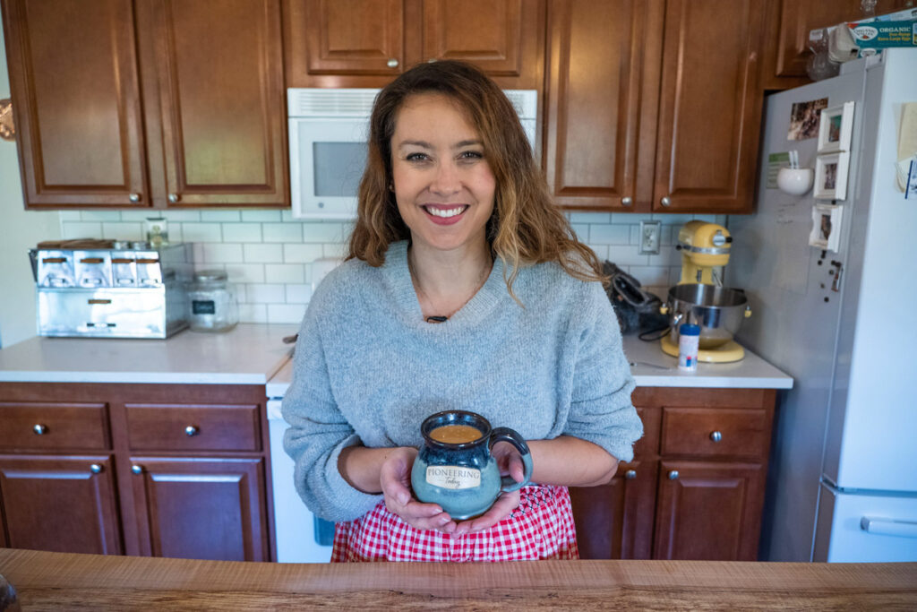 A woman holding a mug of hot chocolate.