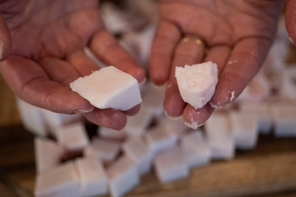 Two pieces of lard in a woman's hands.