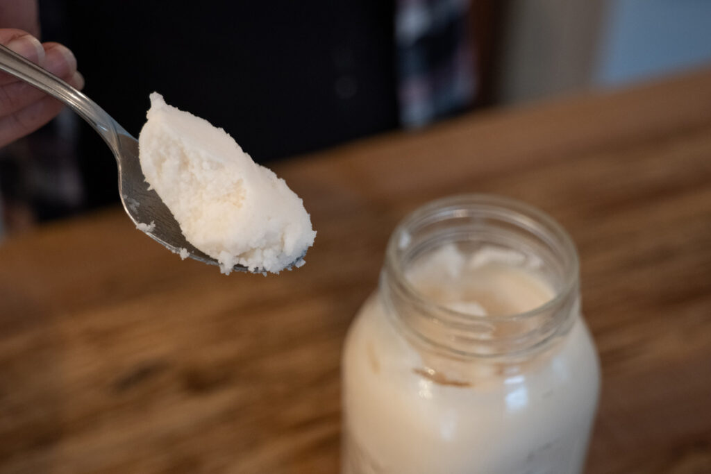 A spoonful of lard from a mason jar.