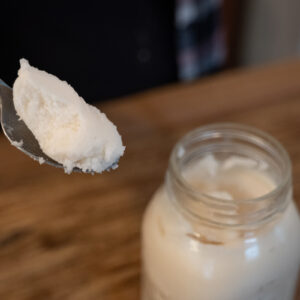 A spoonful of lard from a mason jar.