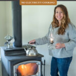Pinterest pin for how to cook on a woodstove. Image of a woman cooking on a woodstove.