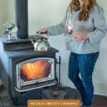 Pinterest pin for how to cook on a woodstove. Image of a woman cooking on a woodstove.