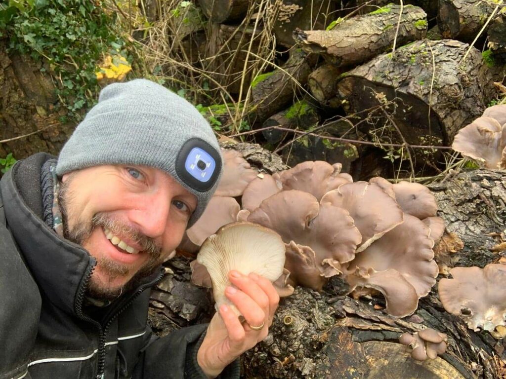 A man foraging for mushrooms.