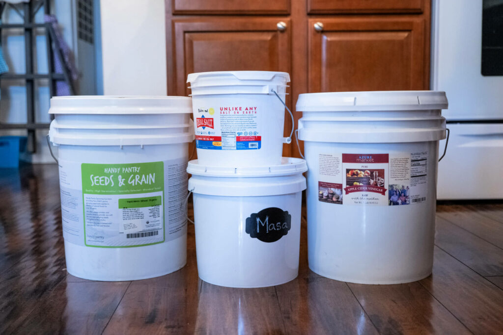 Bulk food in large storage buckets.