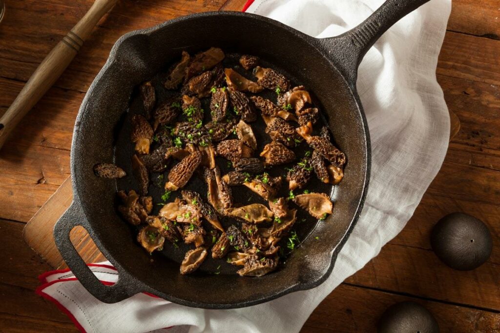 Morel mushrooms in a cast iron pan.