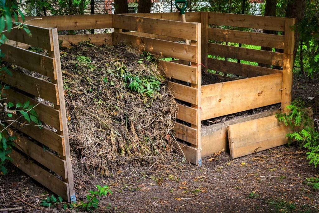 Wooden two-sided compost bin.