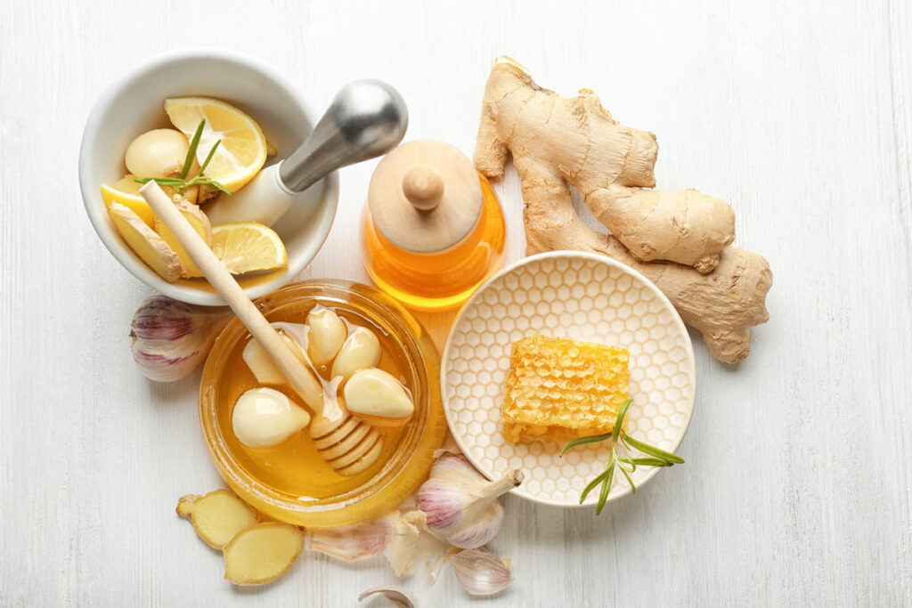 Honey infused garlic on a table with ingredients.