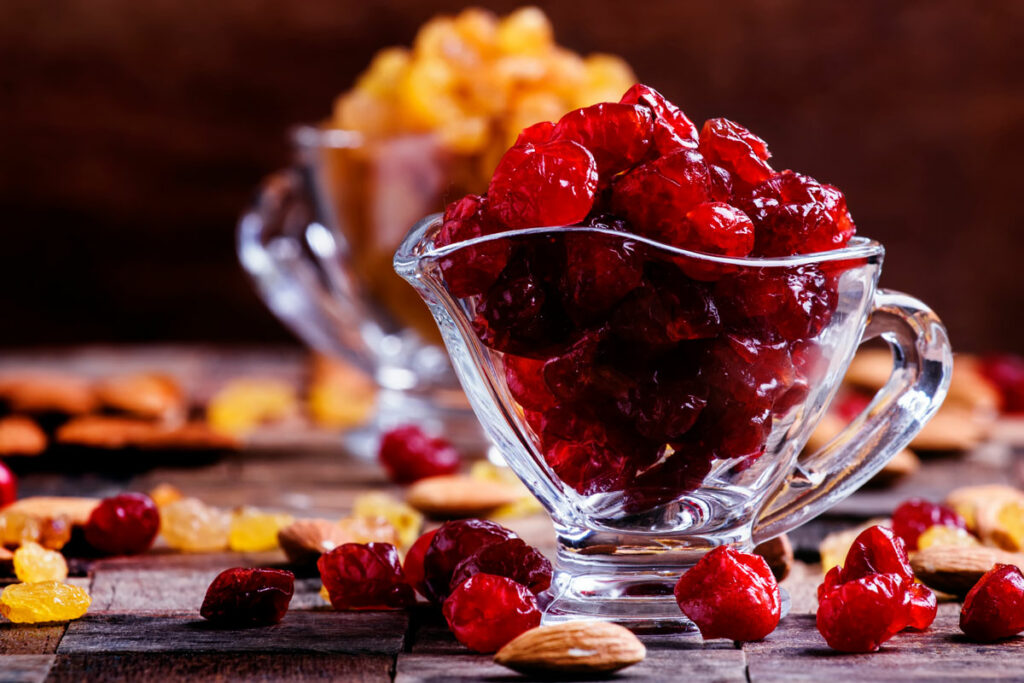Dehydrated cranberries and raisins in glass bowls.