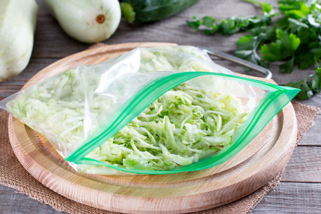 Shredded zucchini in a ziplock bag, ready for freezing.