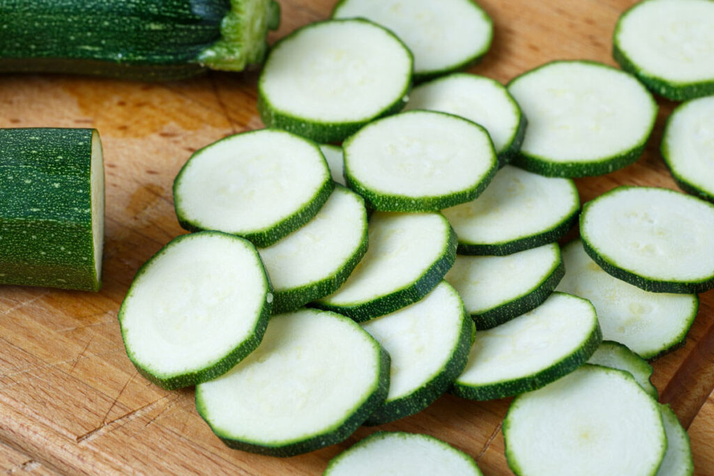 Sliced zucchini rounds on a cutting board.