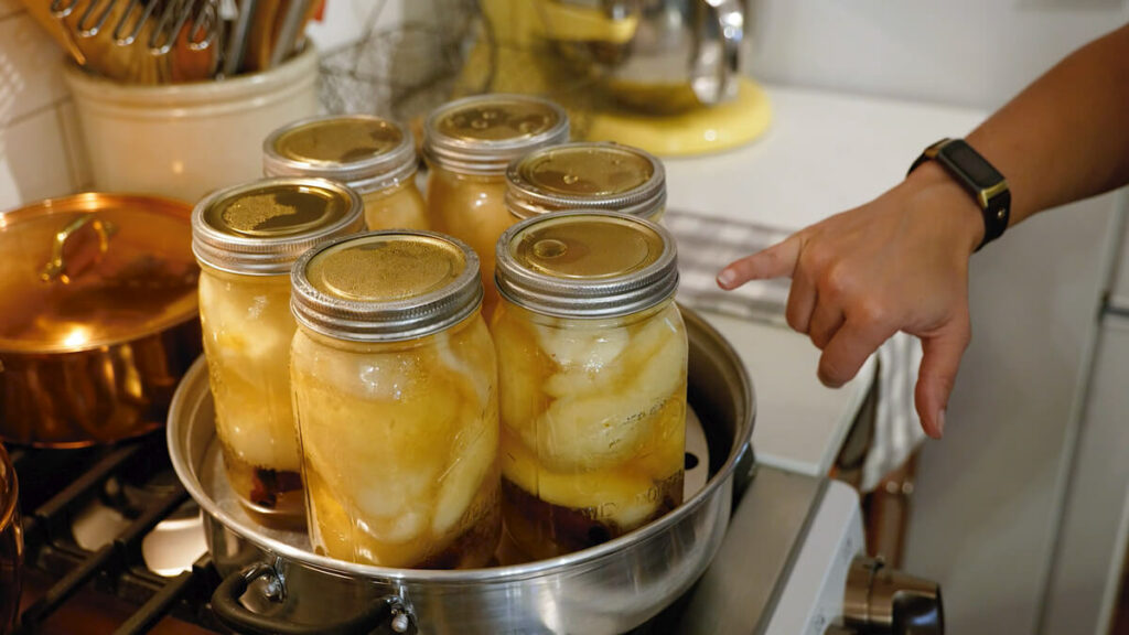 Jars of canned pears in a steam canner.