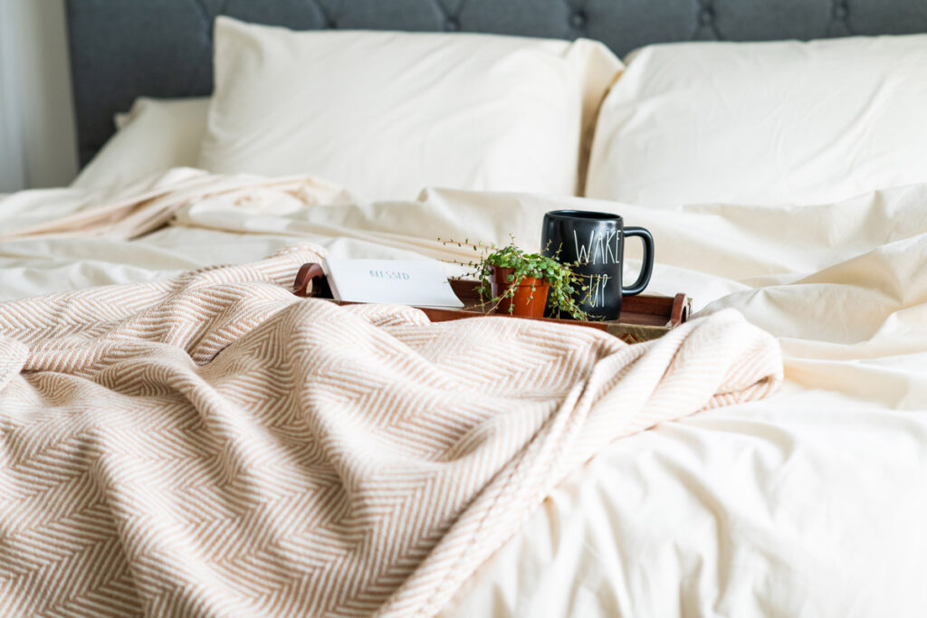 Photos of a bed and a tray with a cup of coffee.