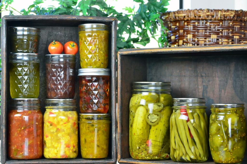 Various canned foods displayed on wooden boxes.