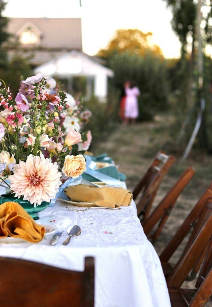 A table lined with fresh flowers as the centerpiece.