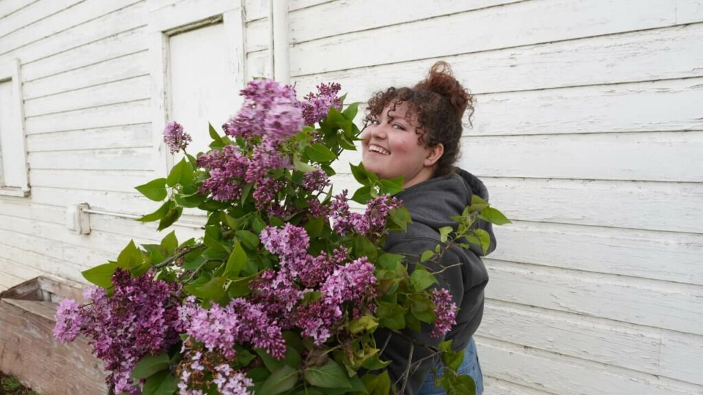 A woman cutting fresh cut flowers.