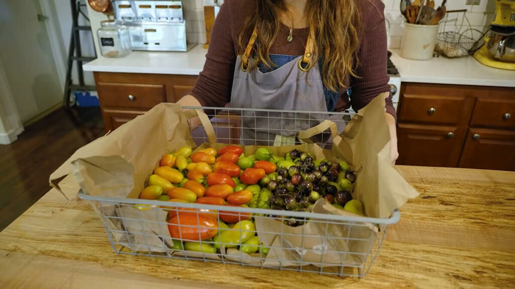 Green and partially ripened tomatoes stored in a basket.