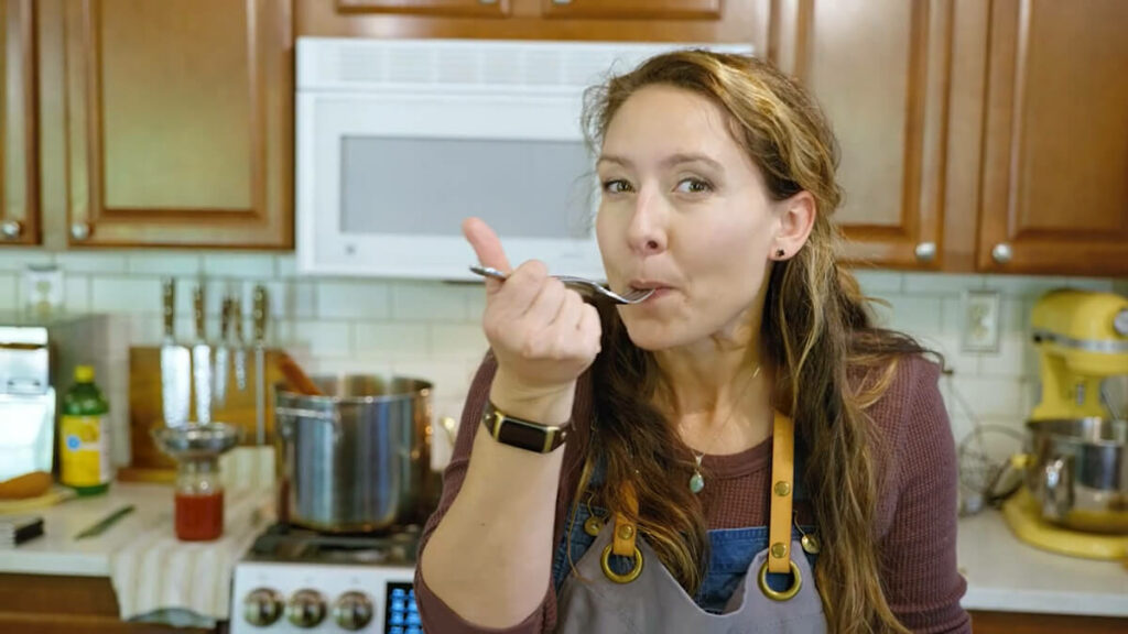 A woman taking a bite of something.