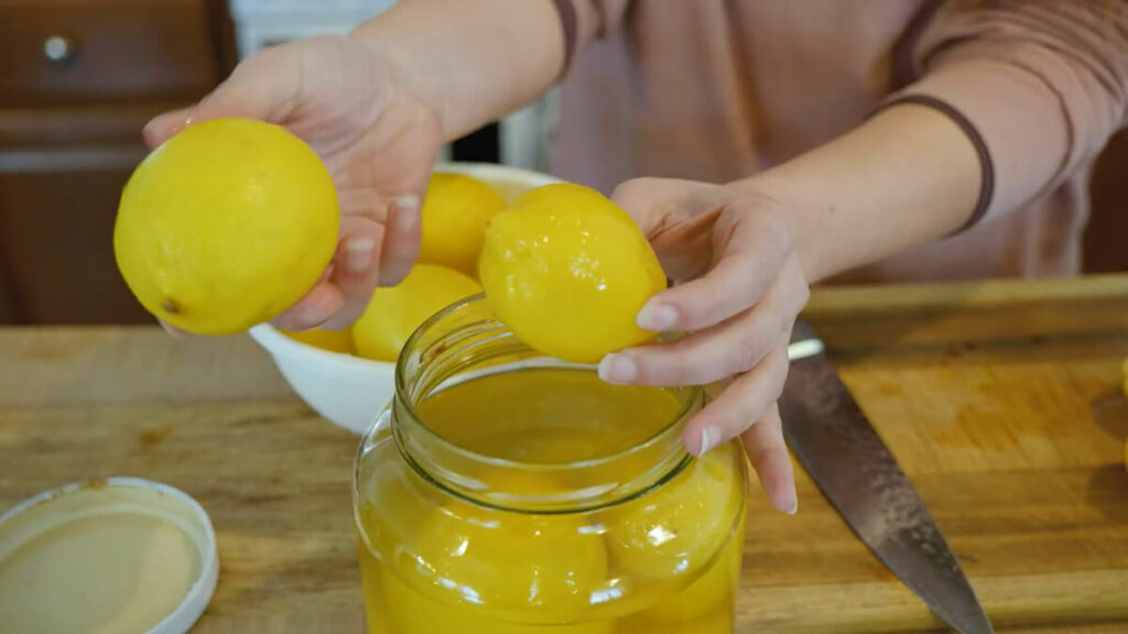 A fermented lemon compared to a fresh lemon.