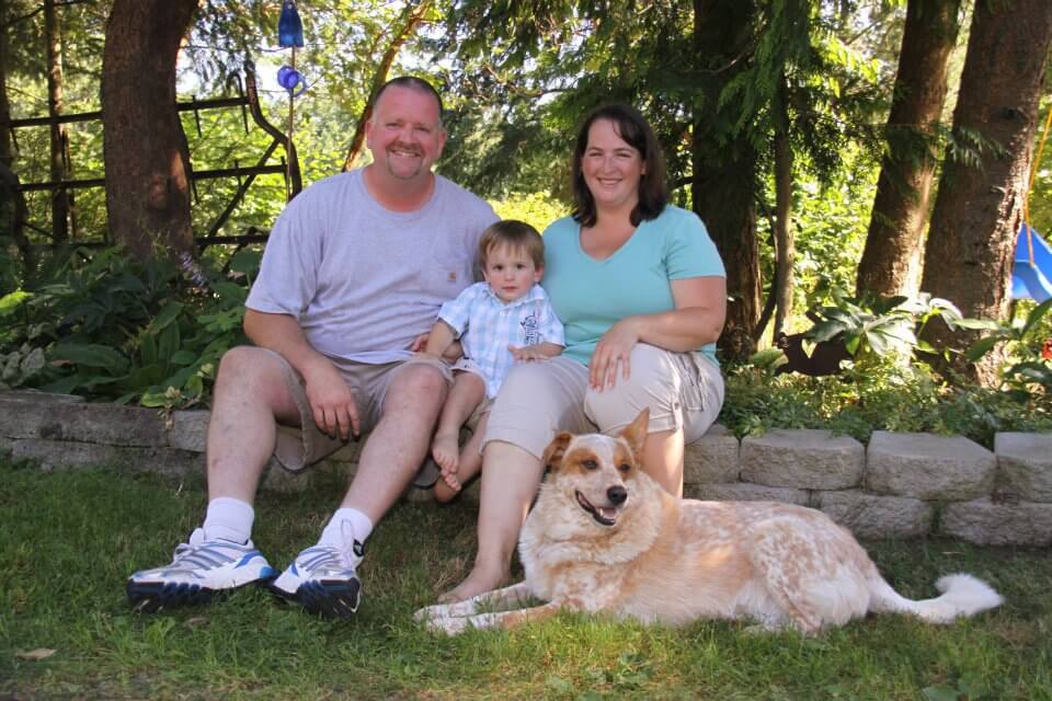 A family and dog posing for a photo.
