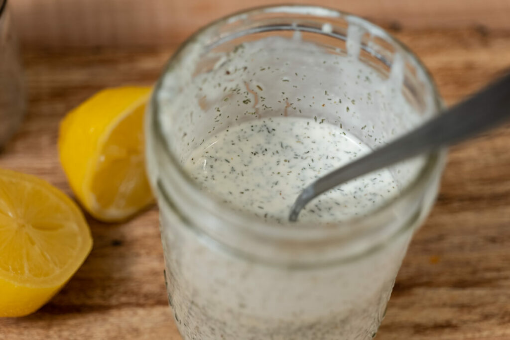 Buttermilk ranch dressing in a Mason jar.