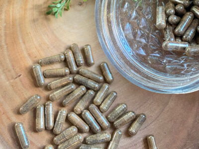 Beef liver capsules on a counter and in a jar.