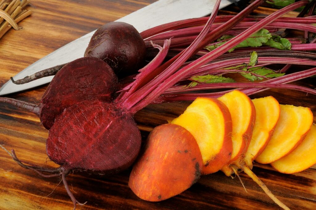 Various beet varieties sliced on a cutting board.