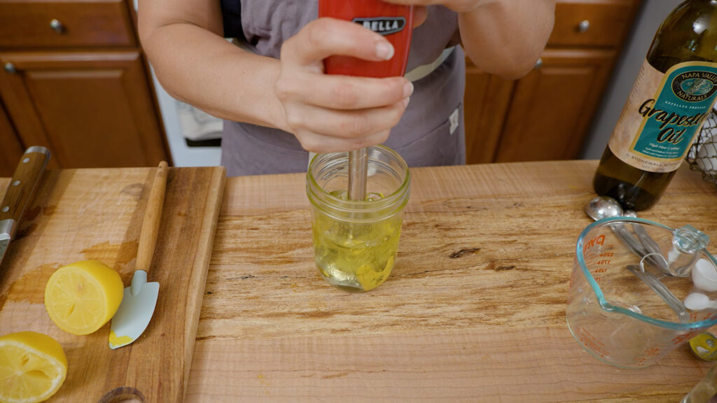 A immersion blender in a jar to make a homemade mayonnaise recipe.
