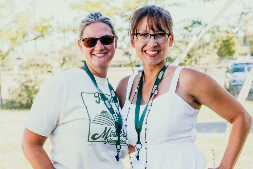 Melissa K Norris and Katie Millhorn pose for a photo.