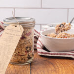 A jar of instant oatmeal mix sitting next to a bowl of prepared oatmeal.