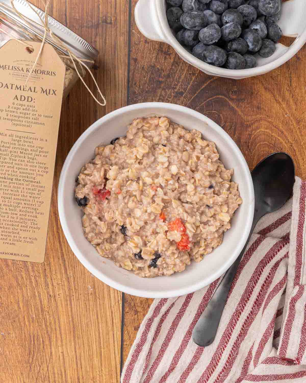 A bowl of oatmeal topped with dried fruit.