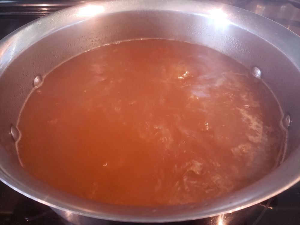 Broth boiling in a large pot.