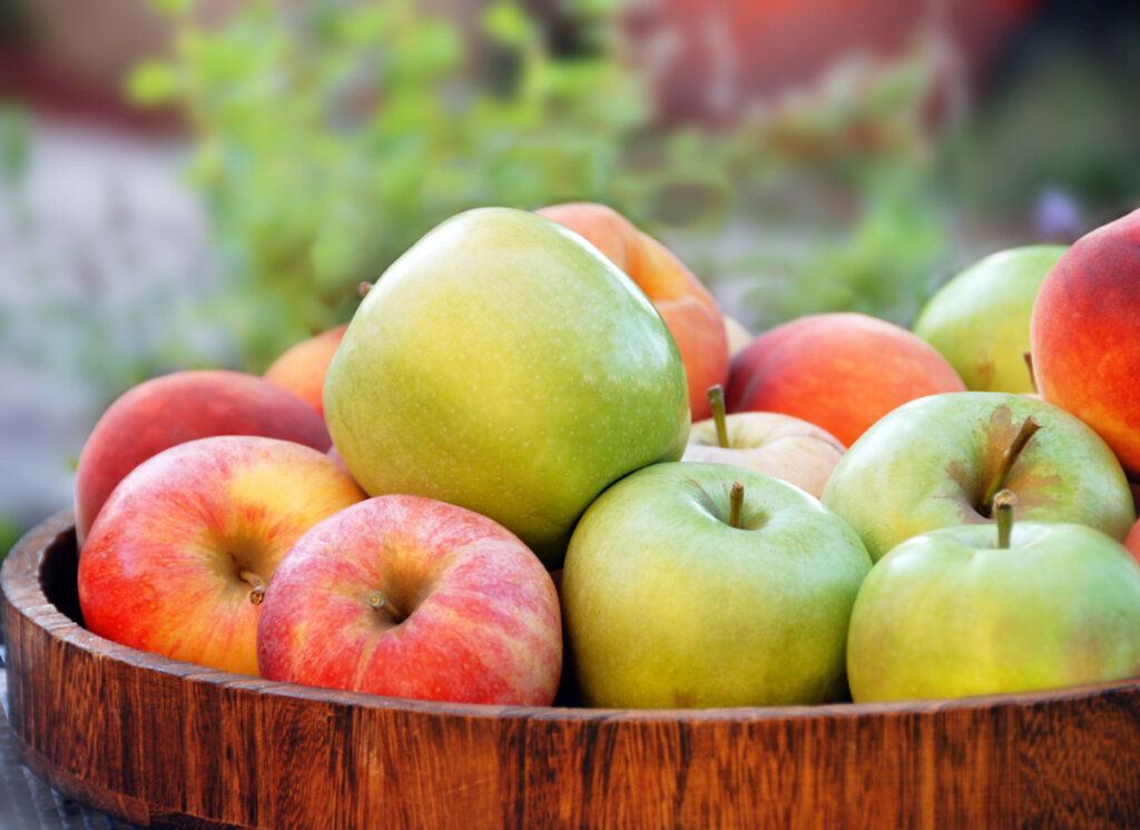 Apples in a wooden barrel.