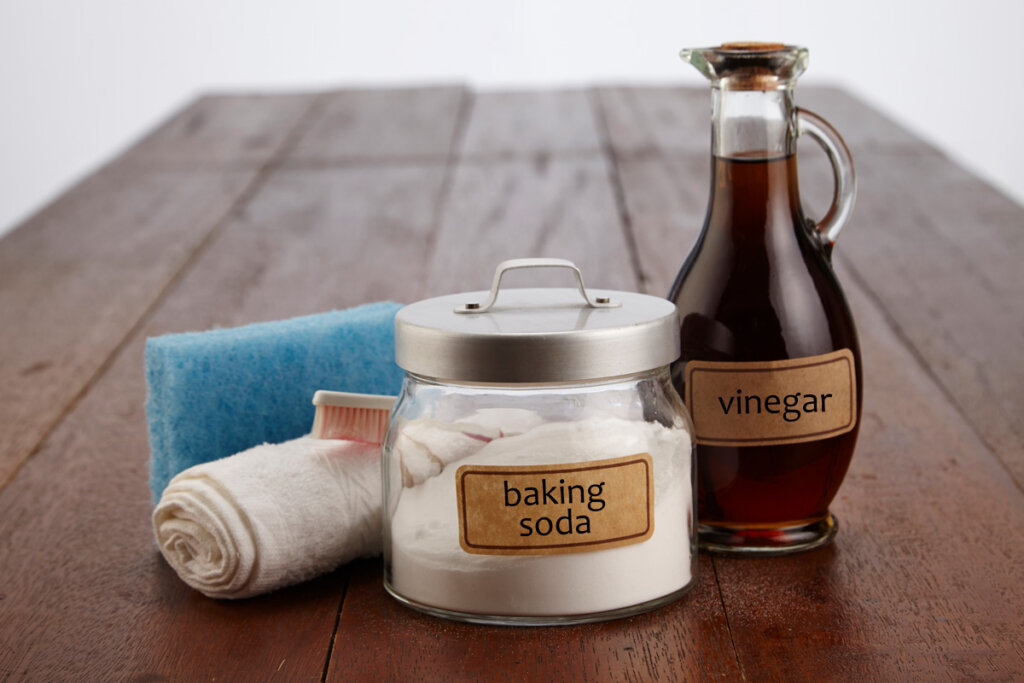 Natural cleaning supplies with baking soda and vinegar.