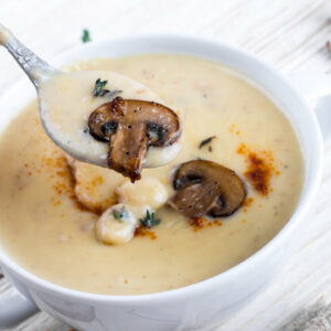 Cream of mushroom soup in a white bowl.