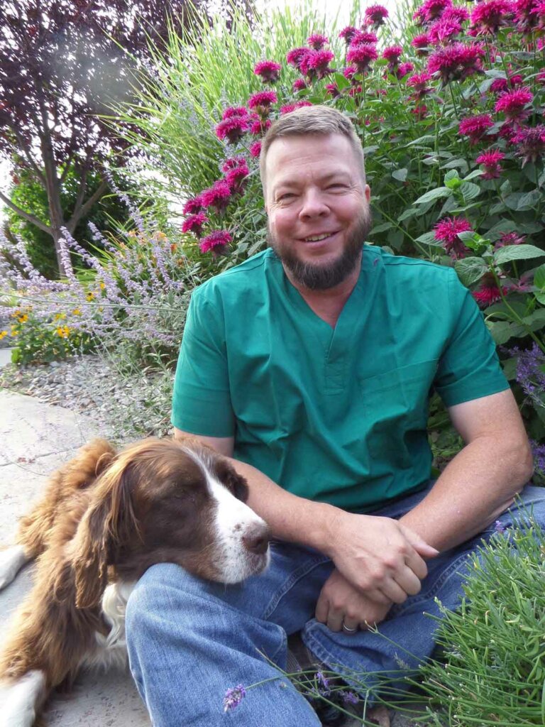 Doc Jones and his dog sitting in the garden.