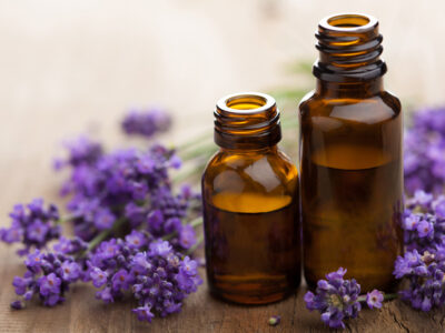 Two bottles of essential oils with fresh lavender.