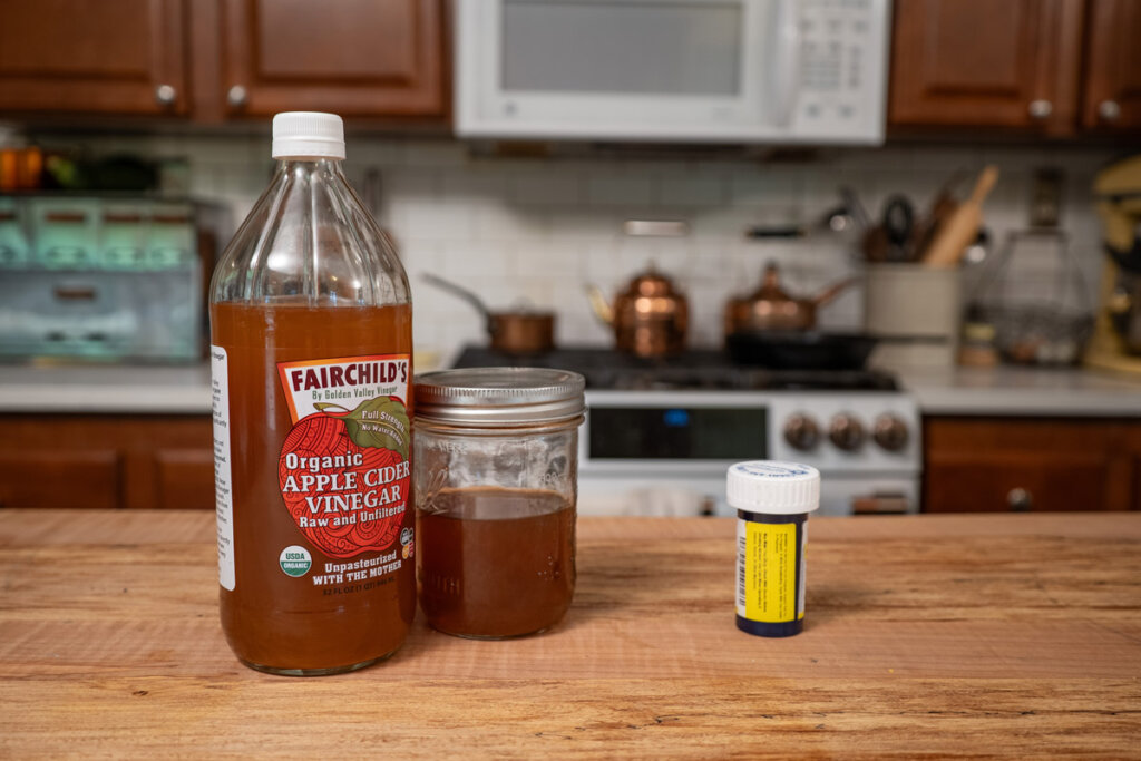 A bottle of Fairchild's apple cider vinegar on a kitchen counter.