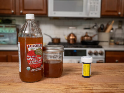 A bottle of Fairchild's apple cider vinegar on a kitchen counter.