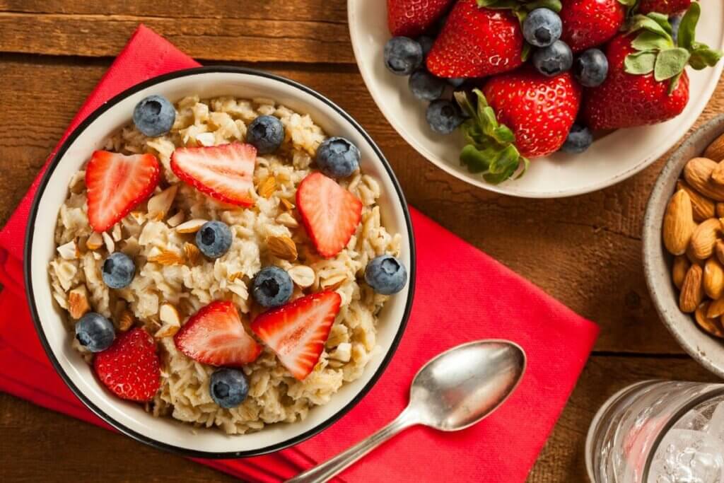 Oatmeal with fruit on top in bowls.