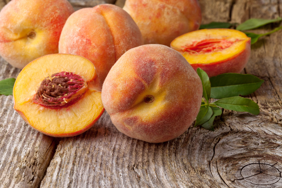 Peaches on a wooden surface.