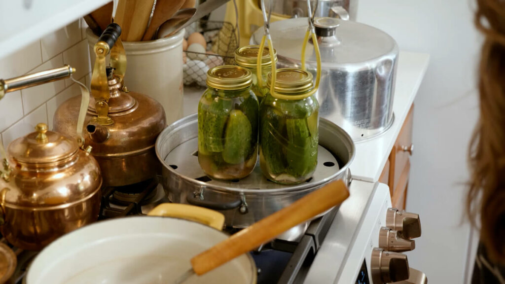 Garlic dill pickles in jars in a steam canner.